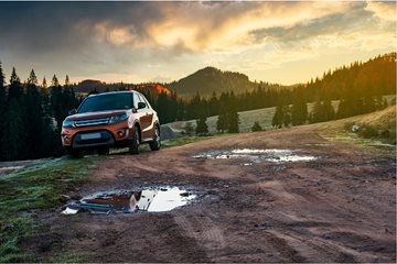 Car driving through the mountains at dusk